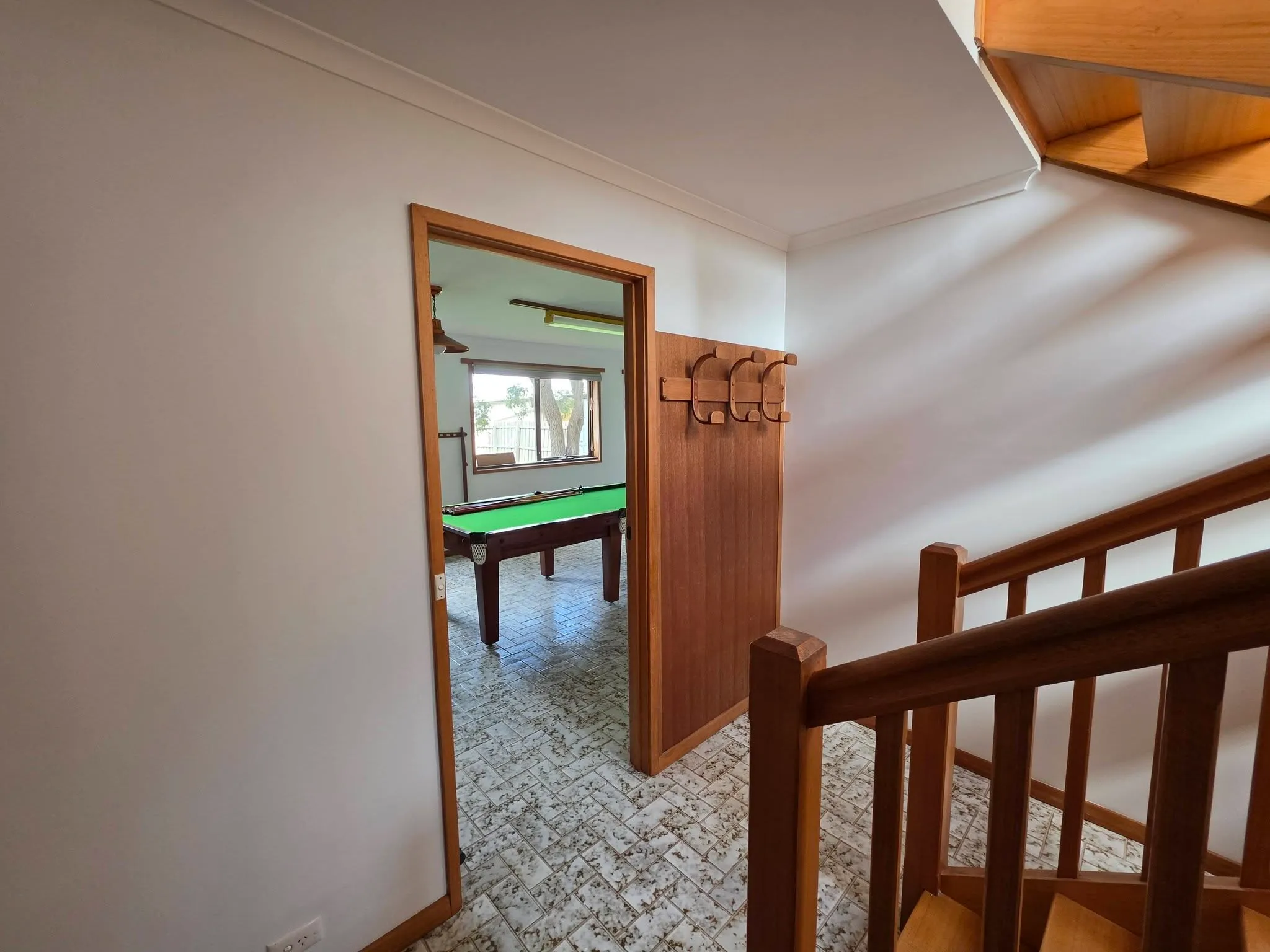 White-painted stair landing and hallway with timber balustrade